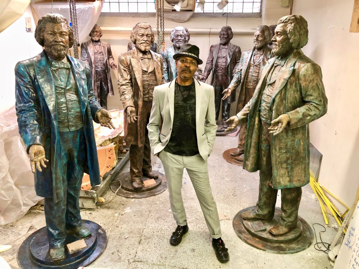 Professor+Carvin+Eison+poses+with+Frederick+Douglass+statues.+%28Photo+courtesy+of+Carvin+Eison%29