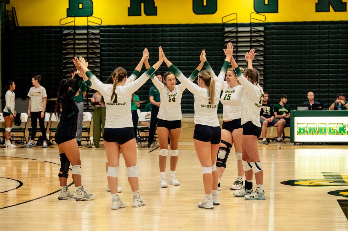 The Brockport volleyball team celebrating a set win Tuesday night. (Photo Credit: Brockport Athletics)