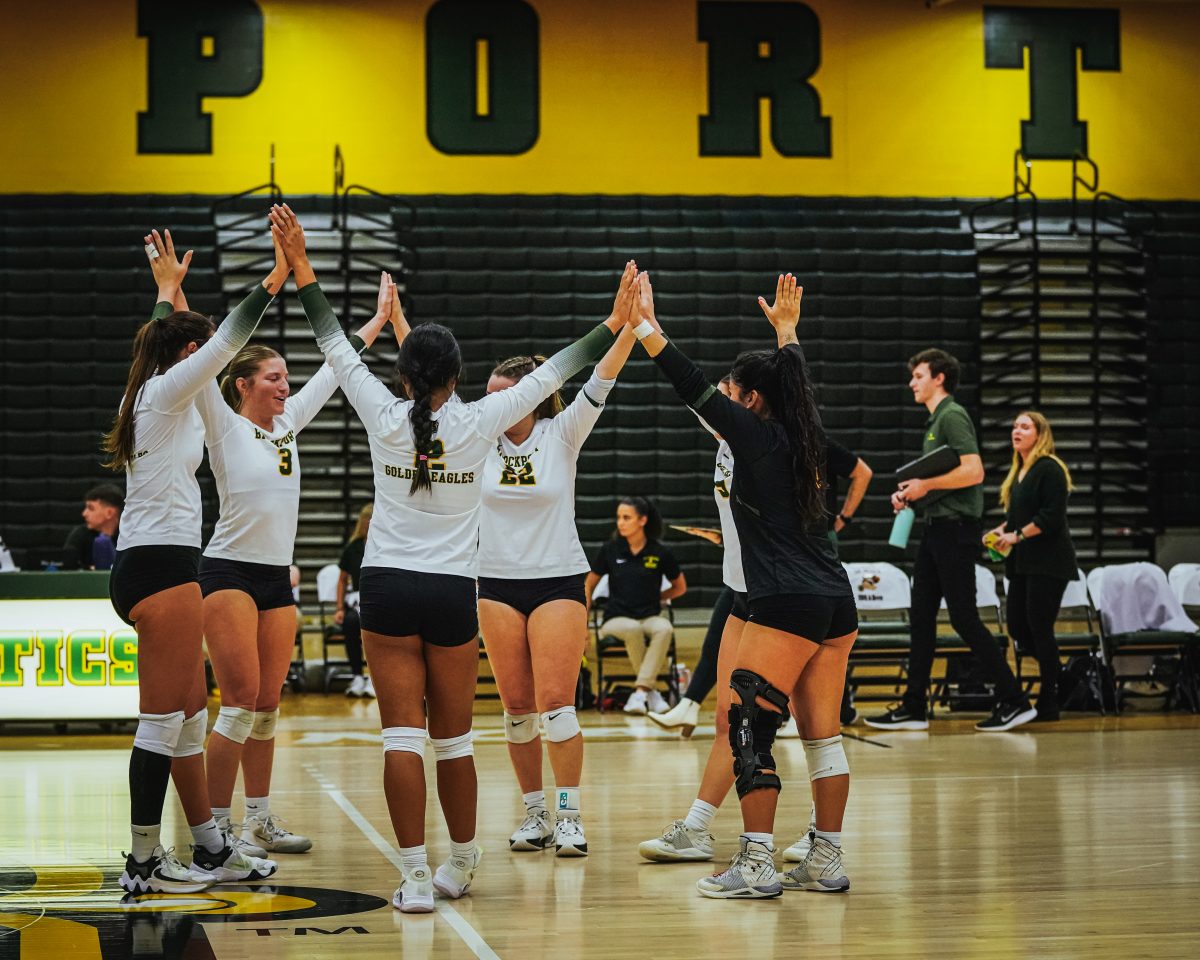 The Golden Eagles celebrating a point victory in the win over  Buffalo State. (Photo Credit: Mathieu Starke)