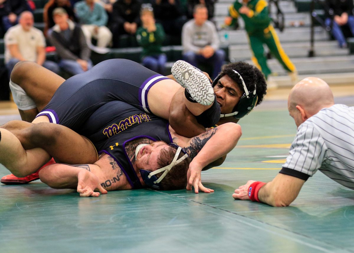 Brockports Kiam Coleman executing the spladle finish to secure his match victory Wednesday night. (Photo Credit: Kat Althouse/Brockport Athletics)