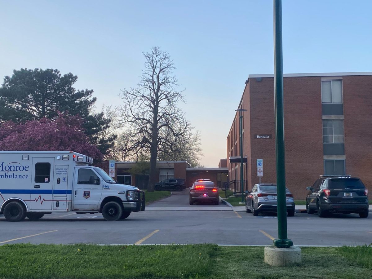 Medical vehicles parked outside Benedict Hall.