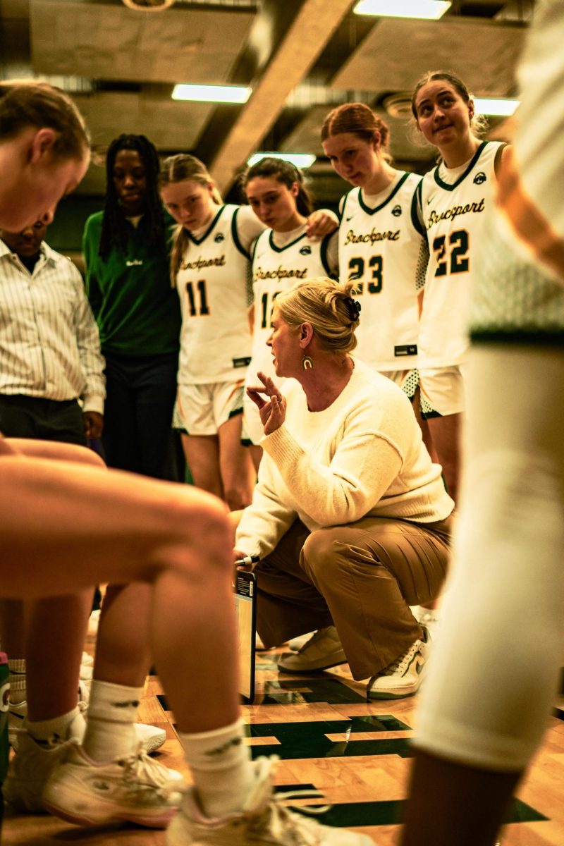 The No. 2 Brockport Golden Eagles and Head Coach Corinne Jones in the huddle during the Empire 8 quarterfinals hosting No. 7 Elmira. 