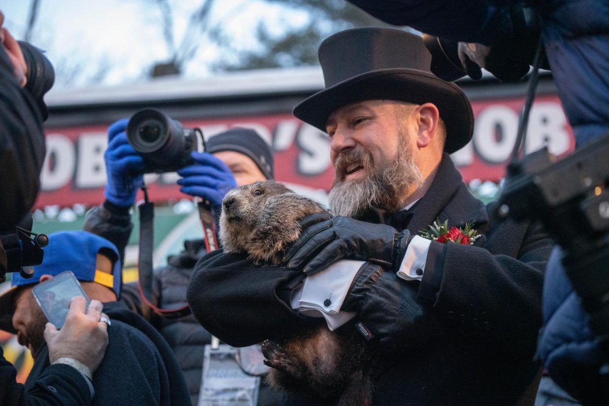 Punxsutawney Phil is held by a member of the Inner Circle during the 2022 Groundhog Day ceremony at Gobbler's Knobb, Feb. 2, 2022 (Anthony Quintano/Wikimedia Commons)