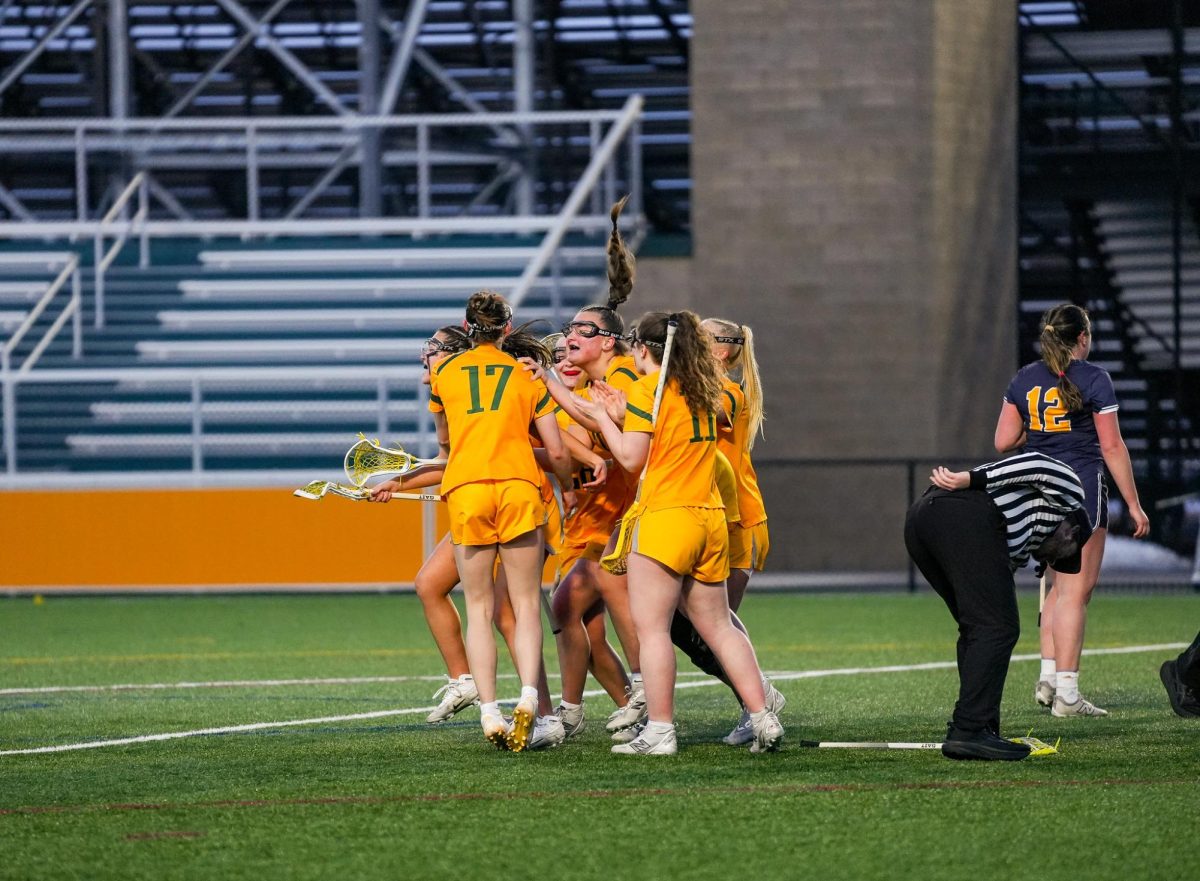 The Brockport Women's Lax squad celebrating it's overtime 9-8 victory against the University of Rochester. 